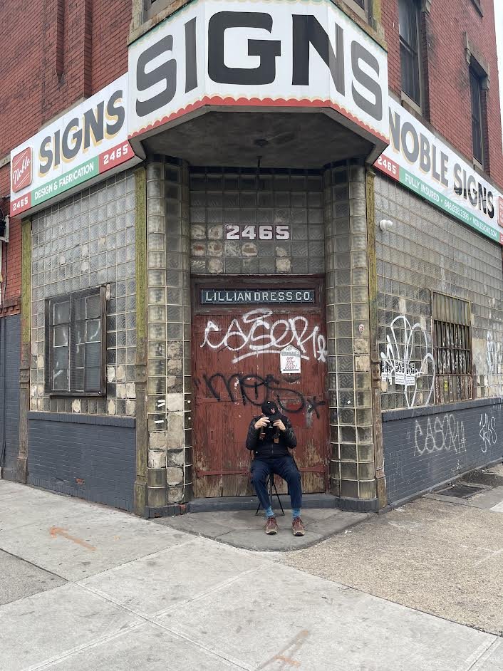  According to Scott Bowman, "Portrait of the artist adjusting the settings" while waiting to be admitted for our tour of Noble Signs, Design Studio &amp; Sign Company,  2465 Atlantic Ave, Brooklyn, NY .   We were warned that we wouldn' t be able to w