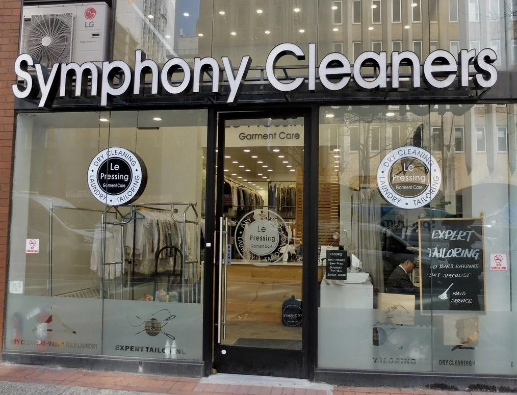  Symphony Cleaners with the tailor wearing a tie. “For the health of our planet and children we use eco-friendly products.”  2024 Best of Manhattan Award Recipient!  "These exceptional companies help make the Manhattan area a great place to live, wor