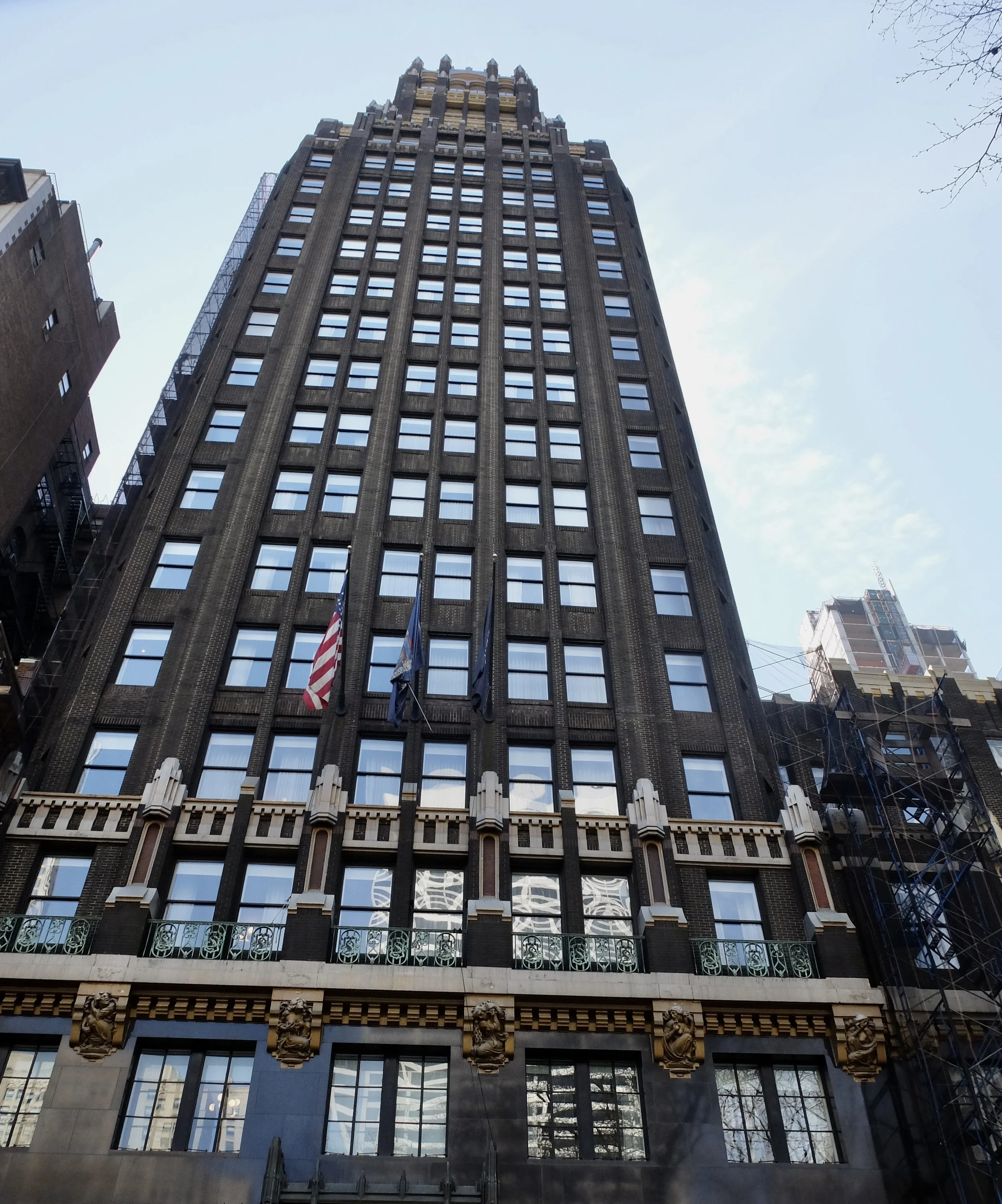  AMERICAN-STANDARD BUILDING ( A.K.A. American Radiator Building)at 40 W. 40th St.   “RAYMOND M. HOOD'S USE OF BLACK BRICK, TRIMMED WITH GOLDEN COLORED STONE, IN THE DESIGN OF THIS BUILDING, IS AN EARLY INSTANCE OF VIVID COLORATION ON THE SURFACE OF A