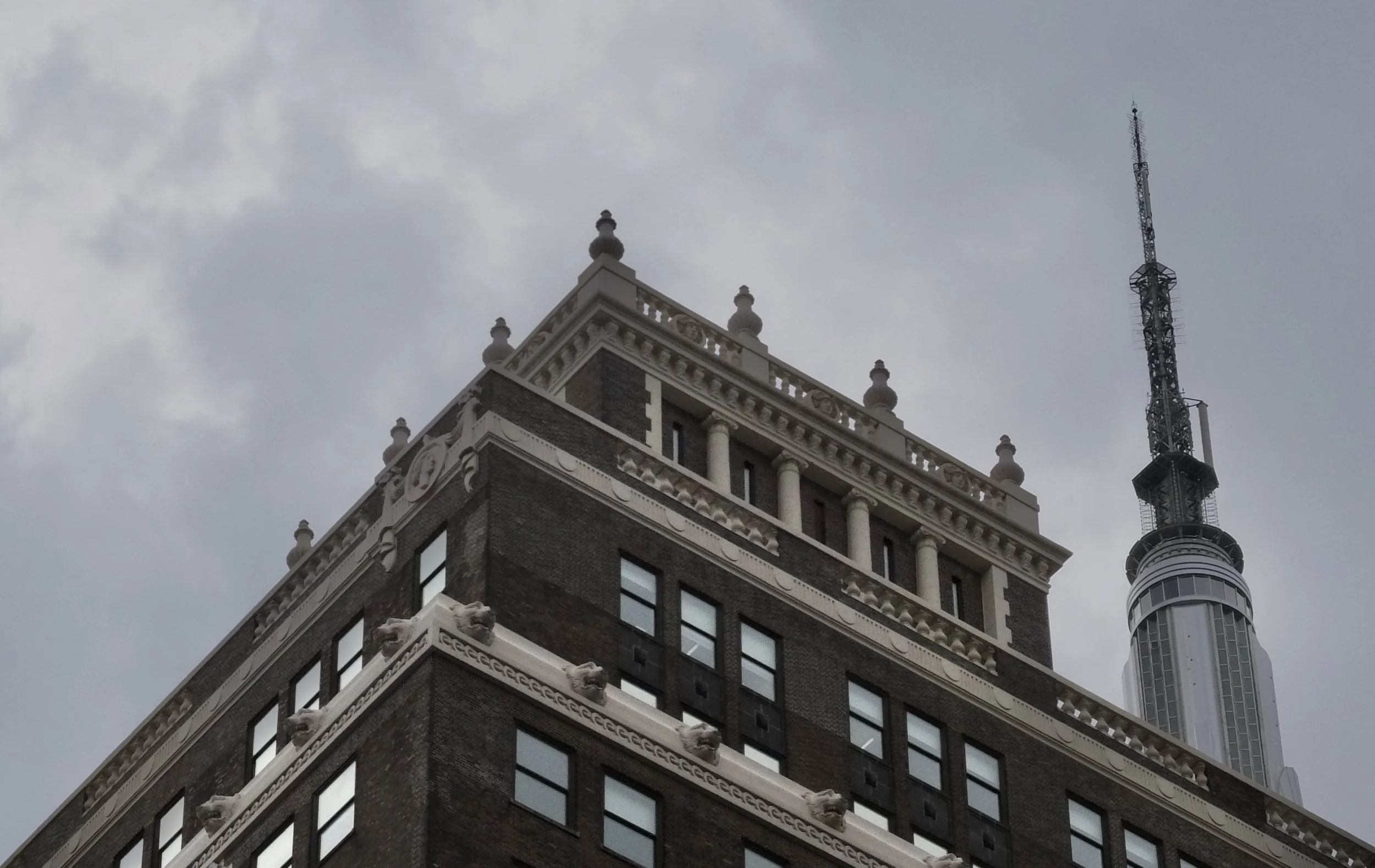  Empire State Building spire &amp; older building’s roof. 