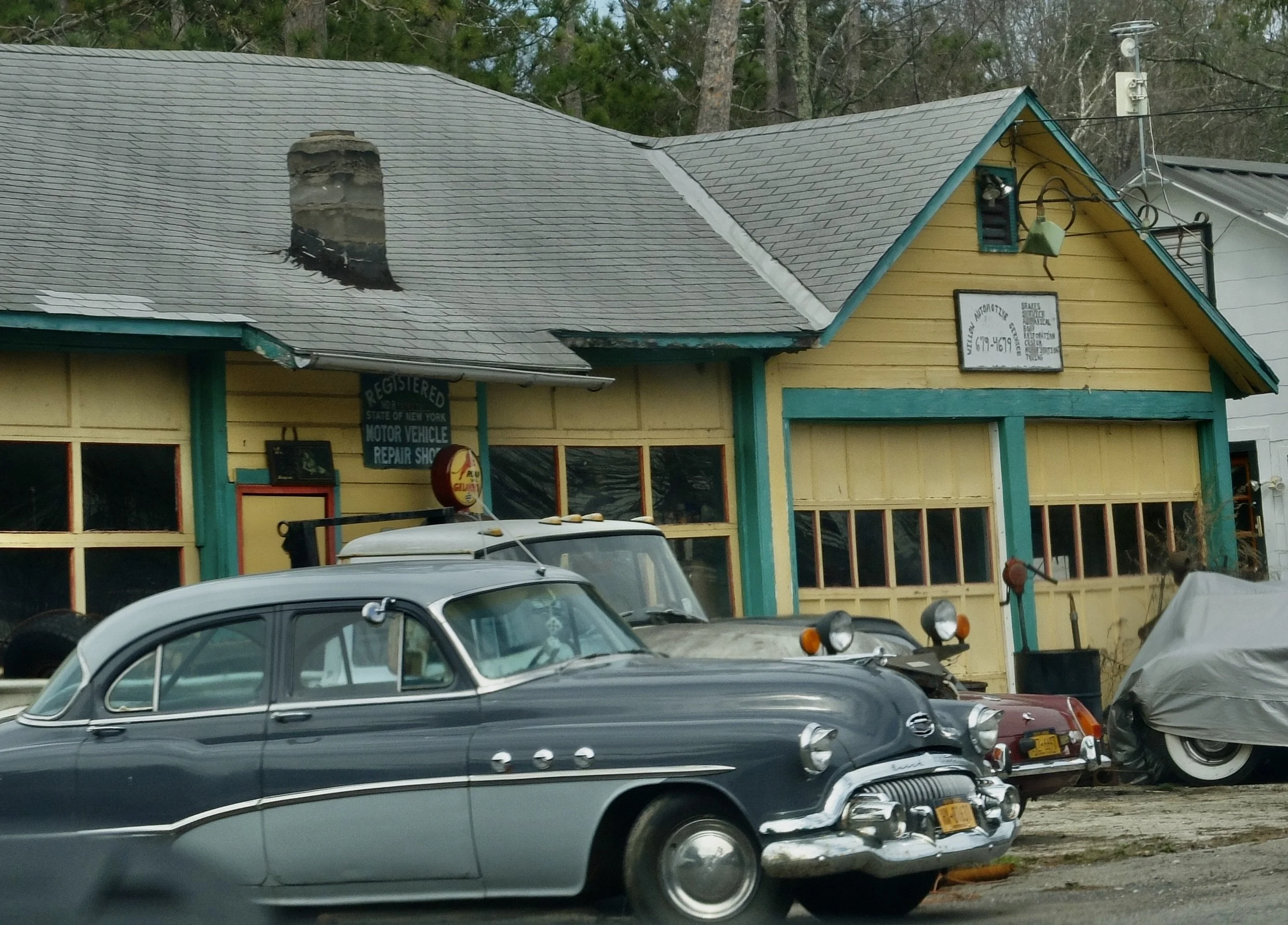  Deteriorating wooden sign &amp; the back end of an MGB peeking out next to the vintage Buick at WILLOW AUTOMOTiVE SERVICE. 