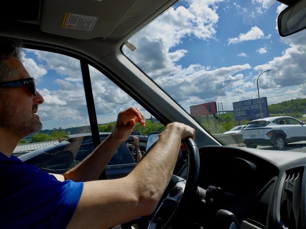  "Prices more stable than some world leaders." (Note the billboard).  Approaching the  MacKay Bridge.  Our driver &amp; guide JD of  Halifax based Grape Escapes-Nova Scotia Wine Tours.  