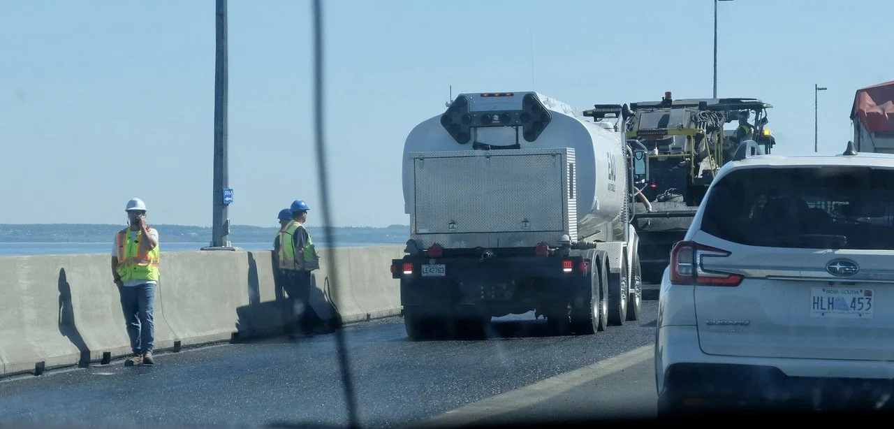  Headed towards Prince Edward Island (PEI) in the middle of the 11 km Confederation Bridge we were stopped for paving work.   