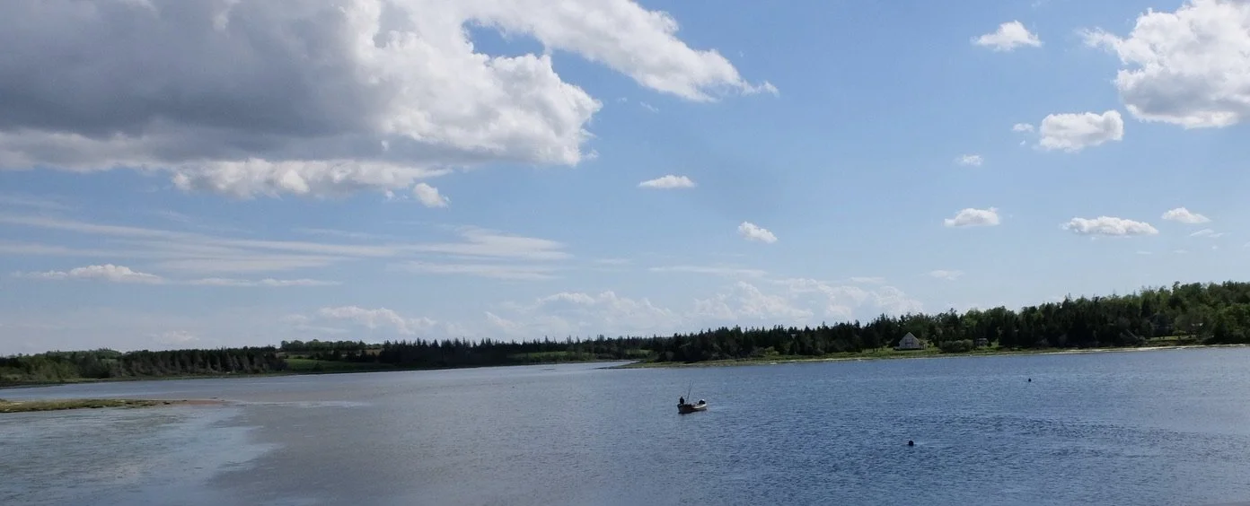  Mussel fisherman in a boat. Cymbria, near the Blue Mussel Cafe, PEI.  The net for the mussels is between those two buoys to the right of the boat.  