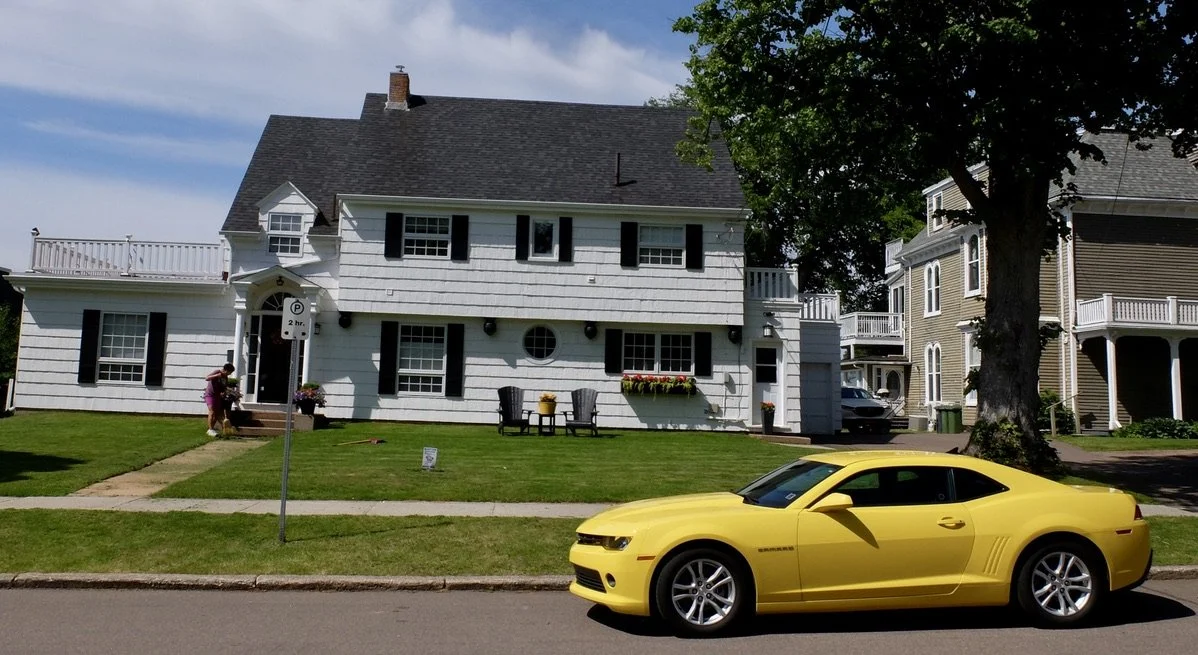  Home owner gardening in an upscale neighborhood along the Hillsborough River, Charlottetown, PEI 