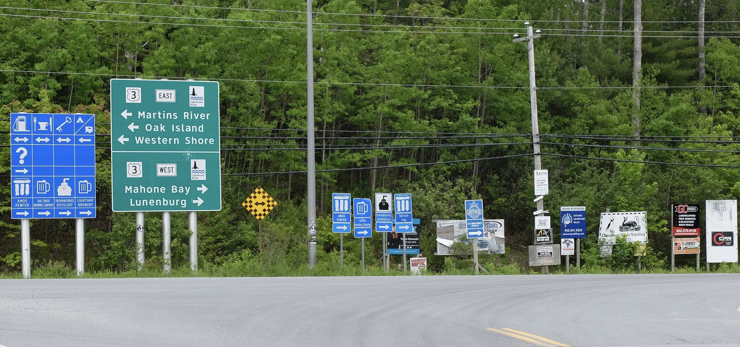  Brewing companies on official road signs.  I had never seen anything like this before. Outskirts of Mahone Bay, Nova Scotia. 