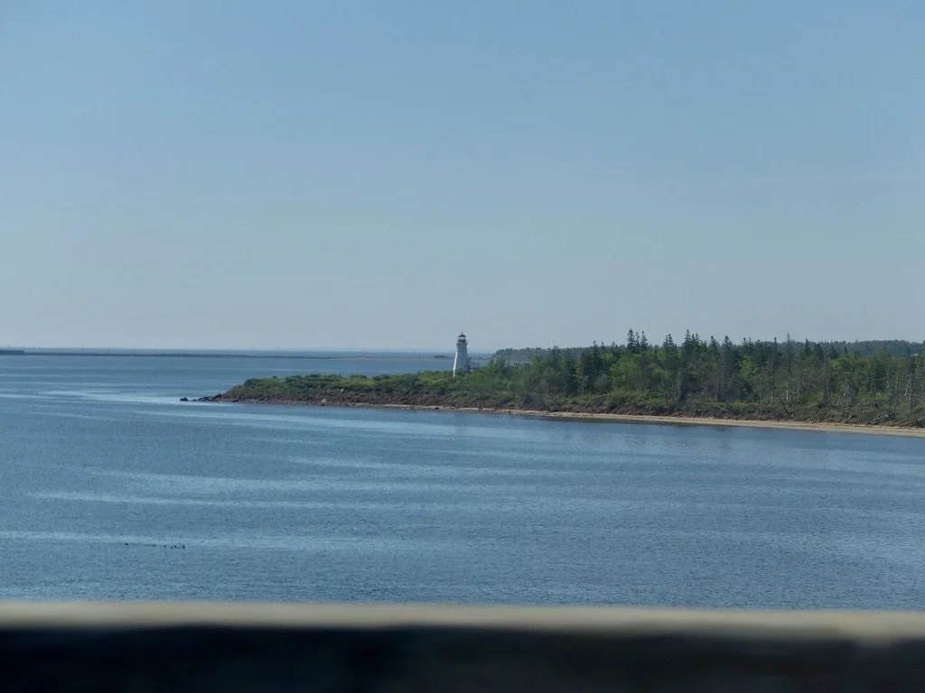  Cape Tarmentine,  New Brunswick from mid-span of the Confederation Bridge.  Our driver factored in the time we would have to wait at the repaving site. ,"...on the Northumberland Strait at the Abegweit Passage, the shortest crossing between Prince E