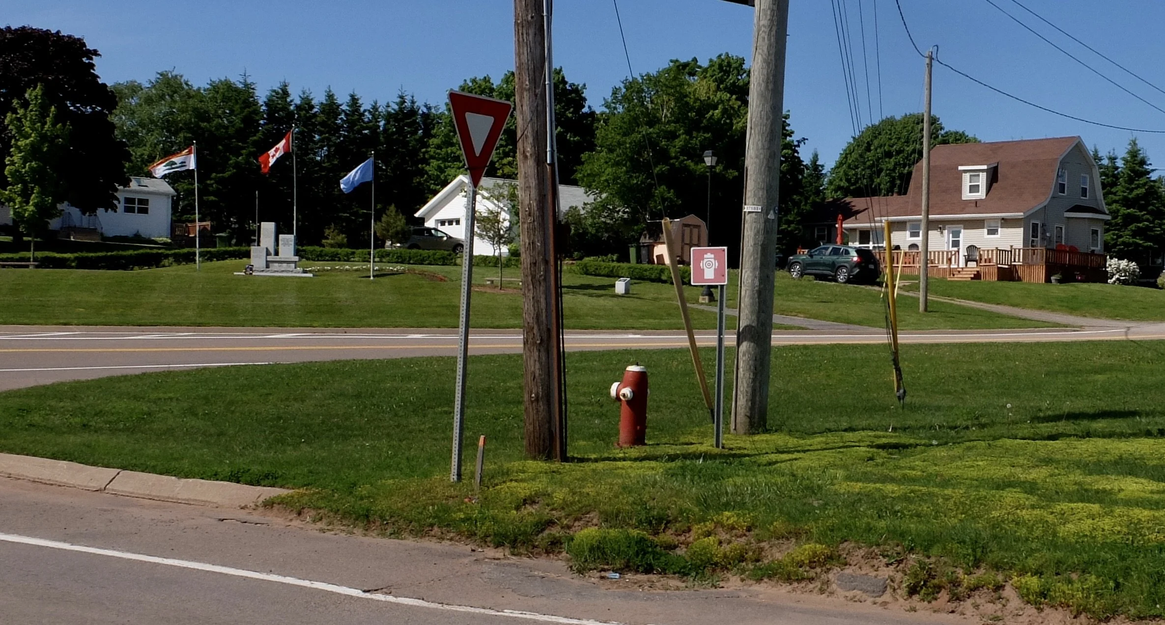  So that’s where the fire hydrant was hiding.  And note once again a U.N. flag.  Cape Turner, PEI. Best of Prince Edward Island Tour.  