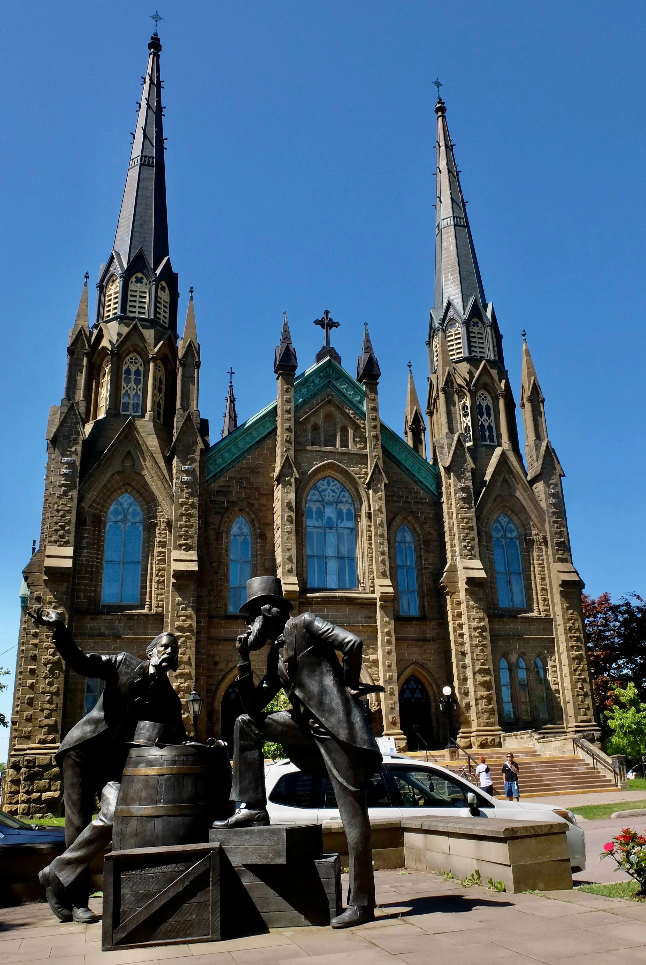  “The bronze statue you see across the street from  St. Dunstan’s Basilica  in Charlottetown, Prince Edward Island, depicts  two men engaged in animated conversation  — a nod to the historic discussions that led to the Confederation of Canada.”  “The