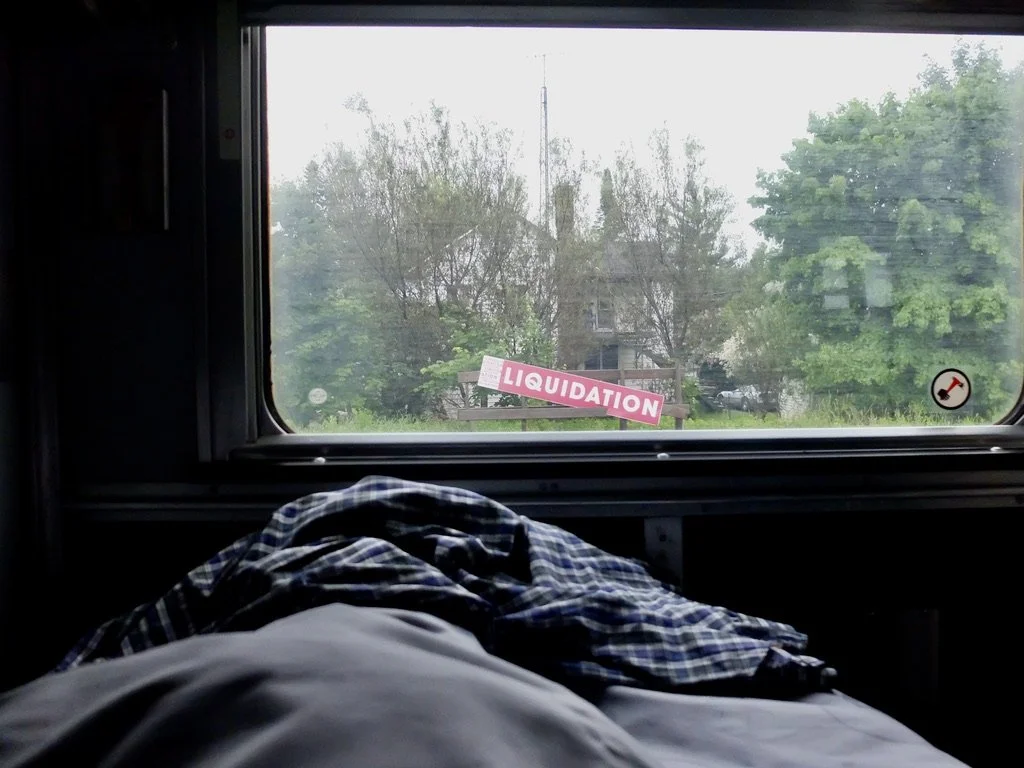  “ LIQUIDATION”  Seen from my sleeping berth on the VIA sleeper train to Montréal.  