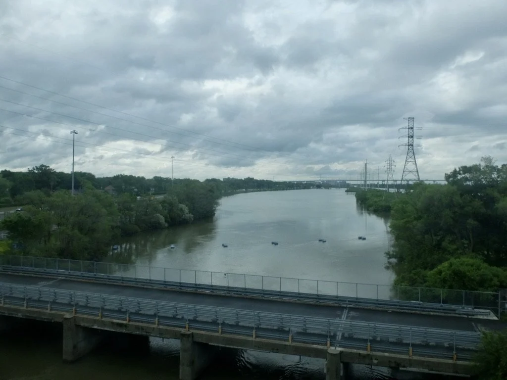  Approaching Montréal on the Victoria Bridge looking at the Samual Champlain Bridge in the distance.  “…a cable stayed bridge with 8 lanes for traffic, plus a multi-use pathway for cyclists &amp; pedestrians) over the St. Lawrence River.”  VIA sleepe