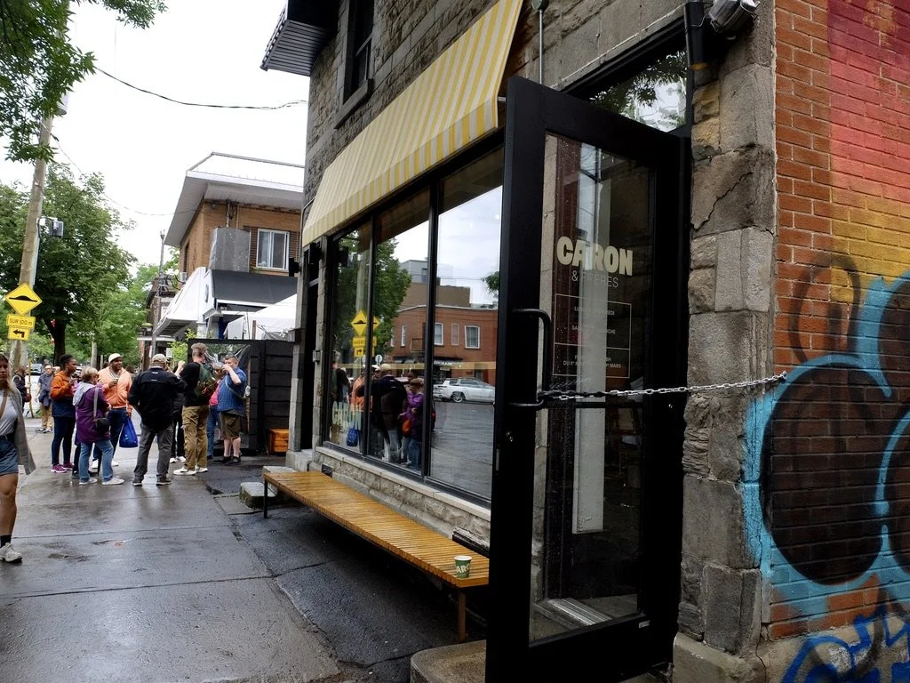  We stopped here for coffee. “The Caron brothers made the gift of becoming their own boss by opening the Café Caron &amp; Frères in Little Italy.”  Note on the utility pole the speed bump caution "SUR 100 m"  Beyond the Market Montréal walking tour w