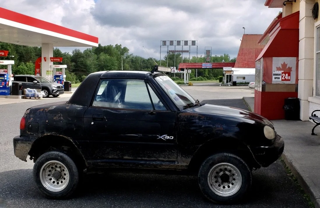  Drive to Québec City for a tour; LE 4 Saisons rest stop.   Neither I nor Mo had seen an auto like this previously &amp; I had to do some research.  “The Suzuki X-90 is a rear- or four-wheel drive, two-door, two-seater offroad automobile incorporatin