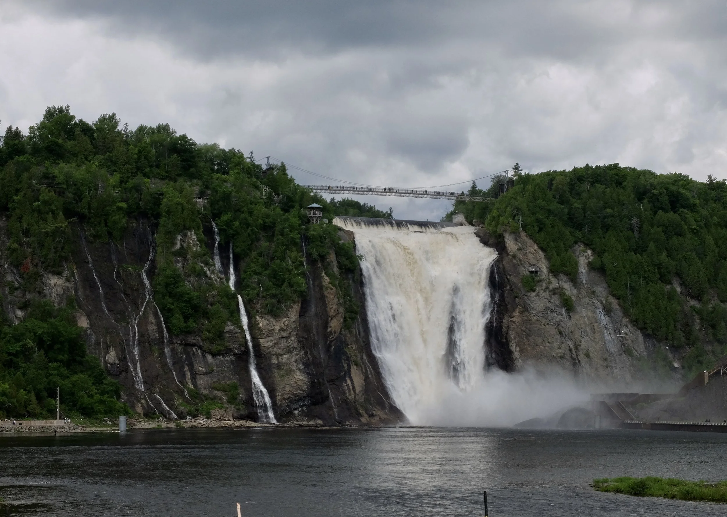   “Montmorency Falls, or Chute-Montmorency in French, is a scenic waterfall found on the outskirts of Quebec City, Quebec. At 272 feet (83 m), it is 30 meters higher than the iconic Niagara Falls but has less volume than Niagara. The falls and river 