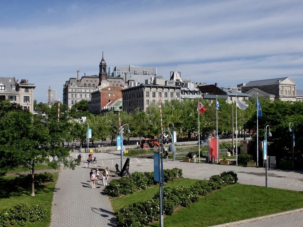  View of Montréal from the Jaqcues-Cartier Quay Old Port.  Straight ahead is the city hall, with the spire &amp; the clock.  Our hotel, the William Grey, was down that block to the left.  