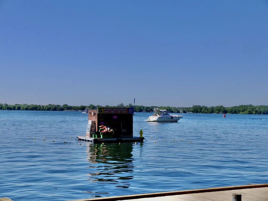  At 1st glance we thought it was a real store where boats could tie up &amp; purchase supplies but…  “A floating convenience store has opened on Toronto's waterfront — but you won’t be able to buy your milk and cigarettes here.”  "Artists Trevor Whea