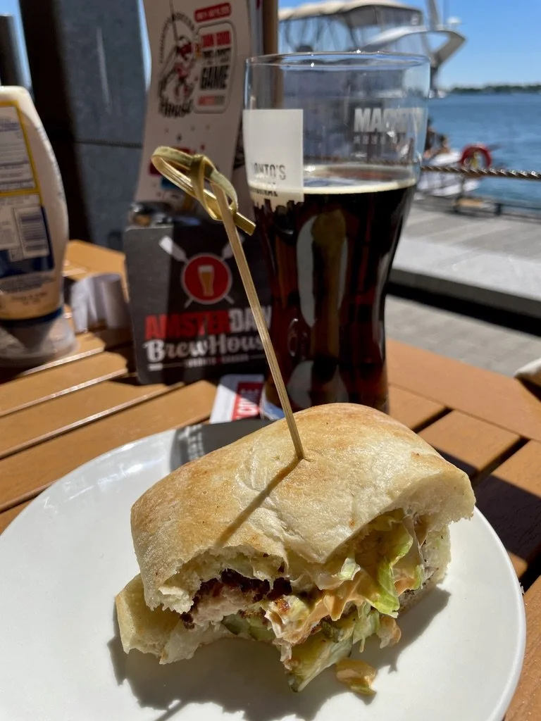  Beyond our fried chicken sandwich you can just make out the women on the boat that the Marine police were approaching.   Amsterdam Brewhouse.  Good food, beer &amp; views. 