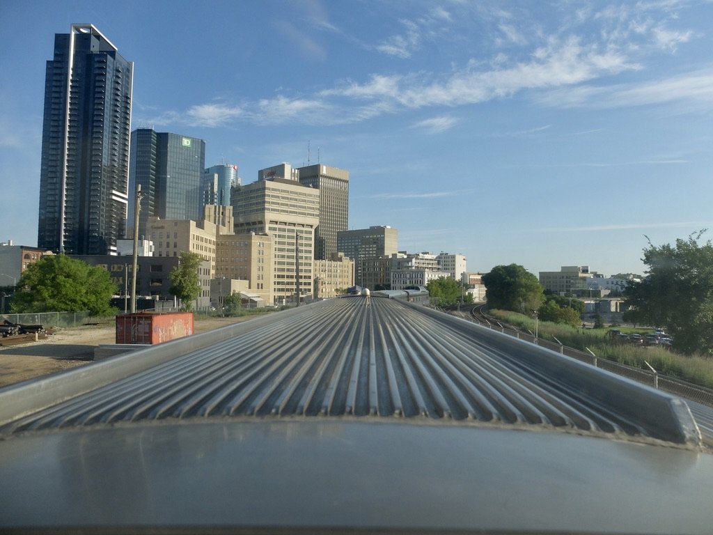  Downtown Winnipeg from The Canadian Skyline Dome car’s clean rear window. 