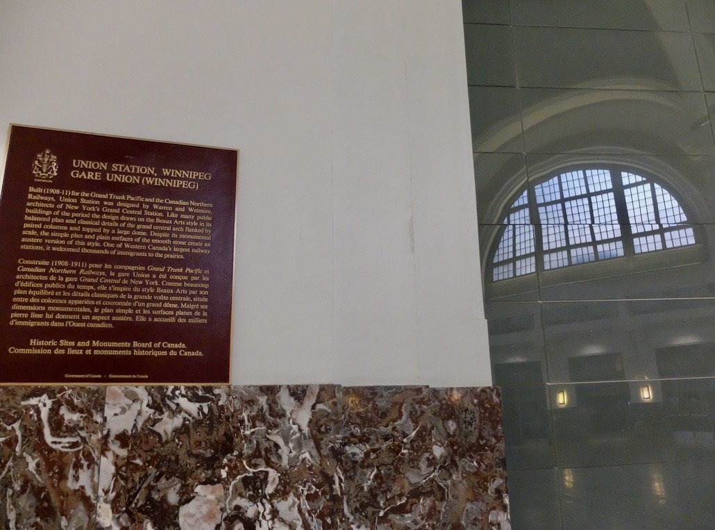  As you can read on the plaque, the Winnipeg Union Railway station had the same designers as Grand Central Station in Manhattan. 