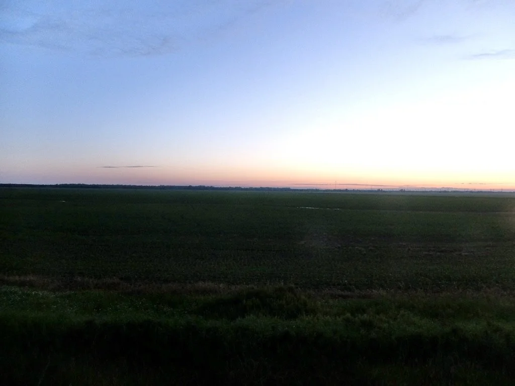  Sunset seen while going forward to the west through Manitoba Province on The Canadian. 