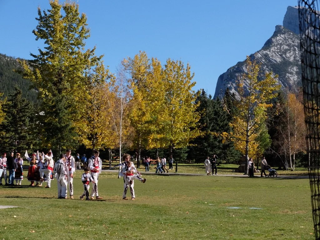  On a gorgeous, sunny Sunday afternoon the local park in Banff had locals &amp; tourists wandering about.  These are local Bulgarians just finishing a dance festival. 