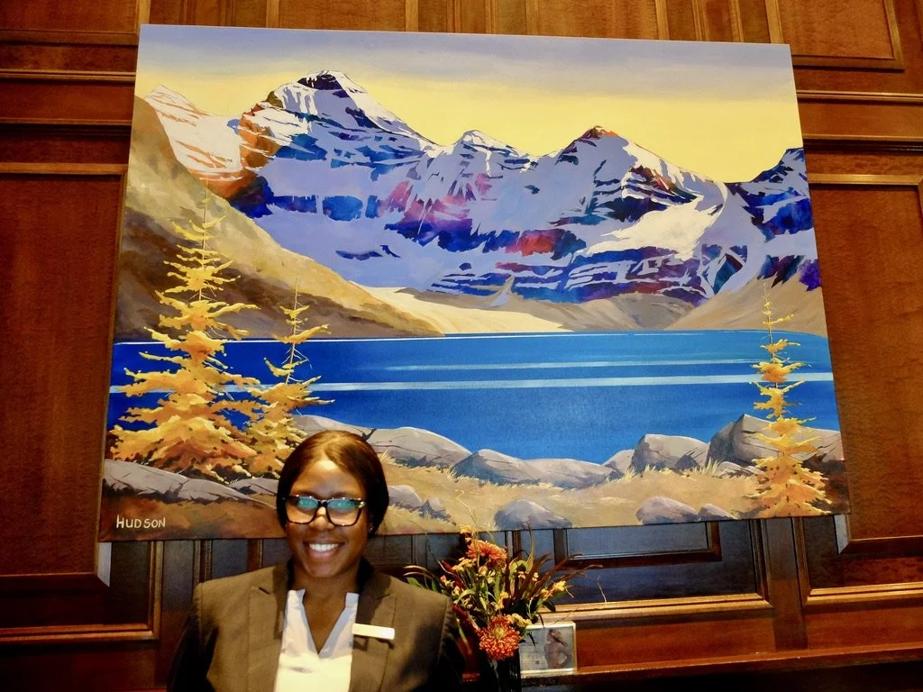  Our receptionist, Amy from Nigeria at the Fairmont Chateau Lake Louise.  She also loved the paintings behind her but never really got to admire them.  She was delighted to inform us that we had an upgrade. Madison, our Travel Designer at Discover Ho