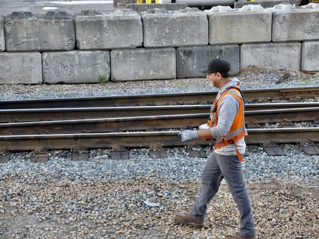  Our train wasn’t moving &amp; I was on the viewing platform so we could talk.  Note how happy he is with his job.  I made him smile.  He got on the freight car again…    