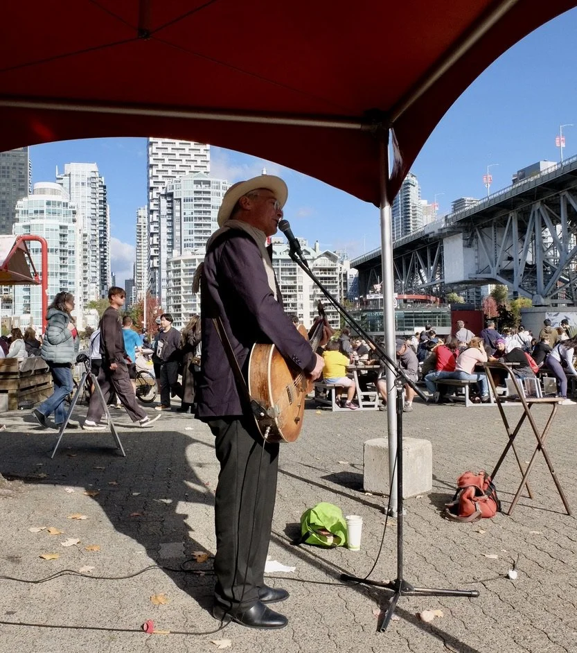  Granville Island.  Joshua Minsky singing a Leonard Cohen song.  He also performed a number of French songs.  I bought his most recent CD  La bohème.   Joshua’s from Brooklyn with family from Romania &amp; Poland.  Back in 1976, he even lived for a y