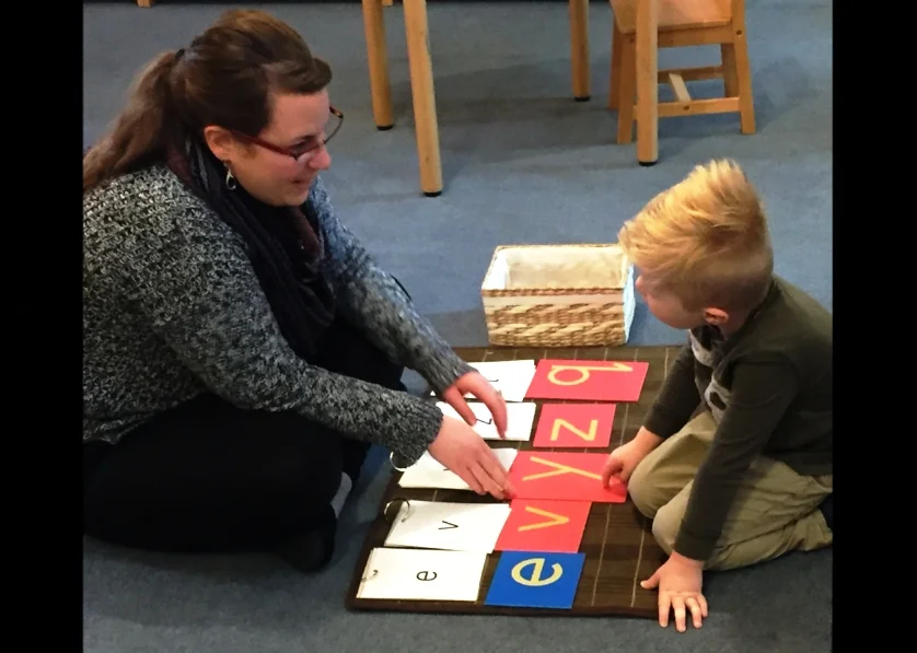 Our new preschool teacher, Jessie O'Brien and William working with the sandpaper letters.