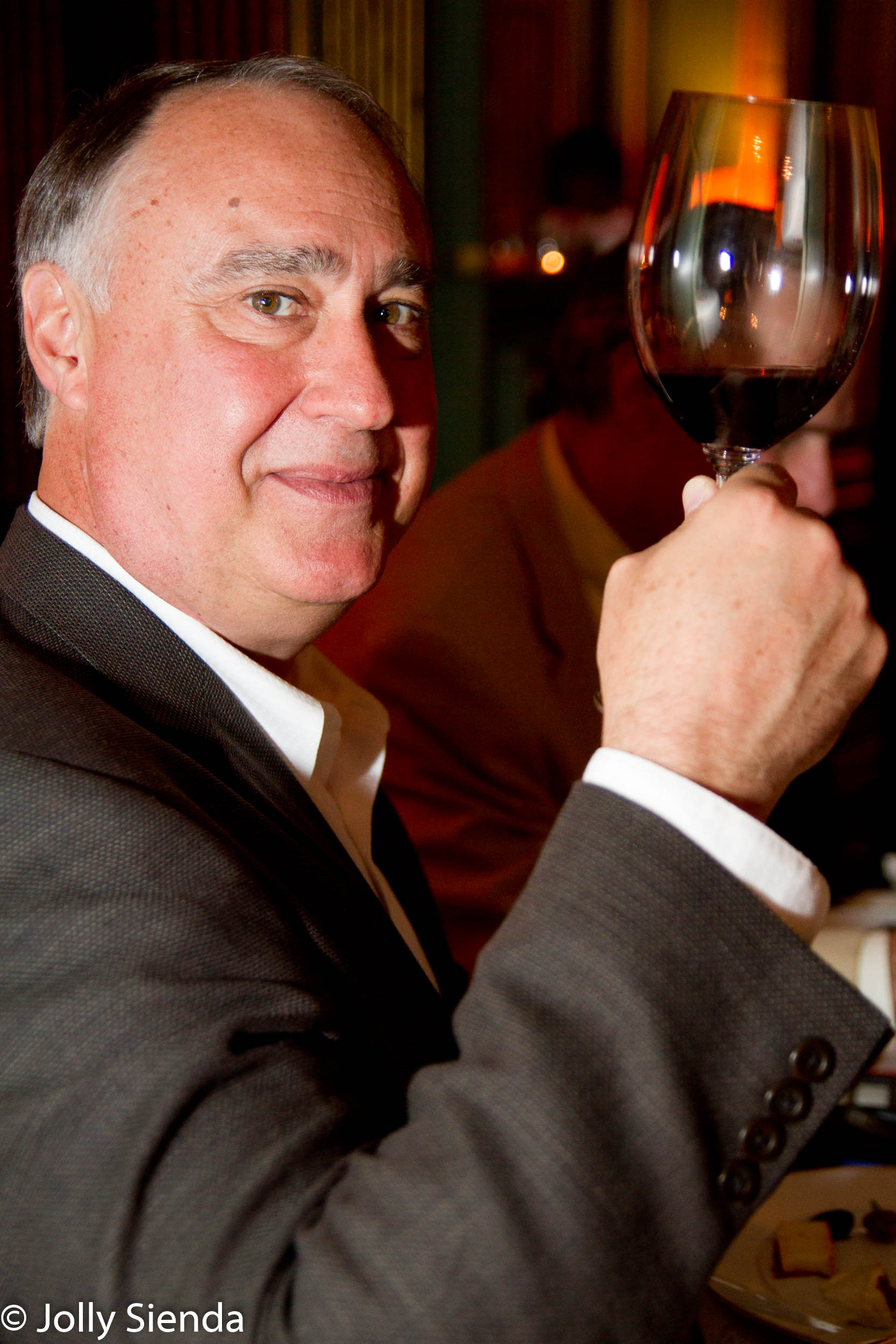 Portrait of a man making a toast with a glass of wine