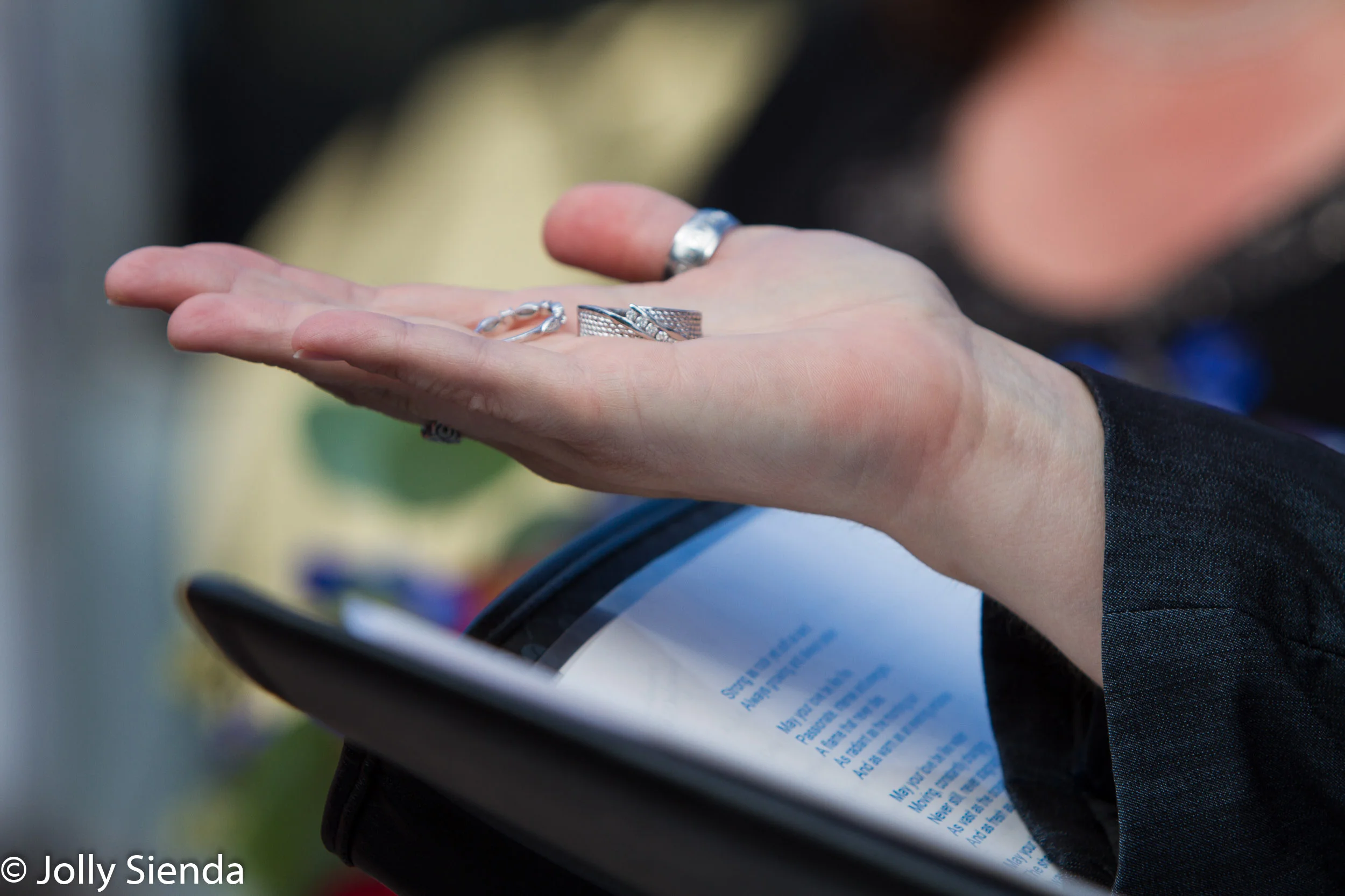 Officiant holds the wedding rings, wedding photography