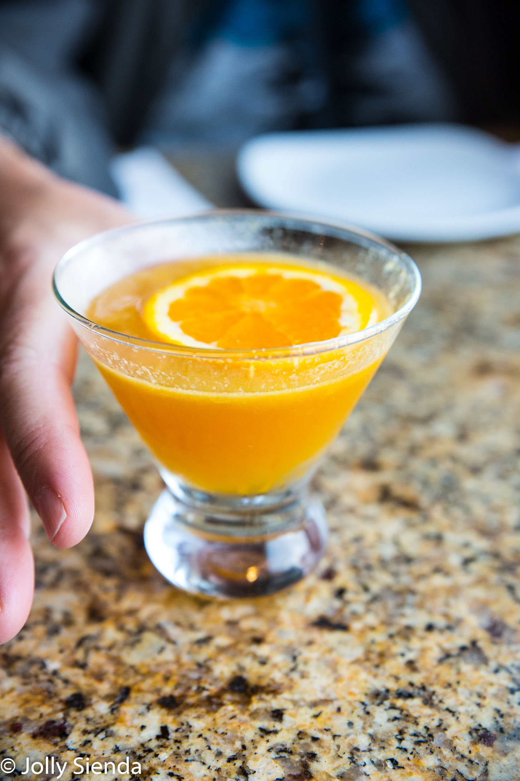 Handling a fresh orange juice and vodka cocktail with a fresh or