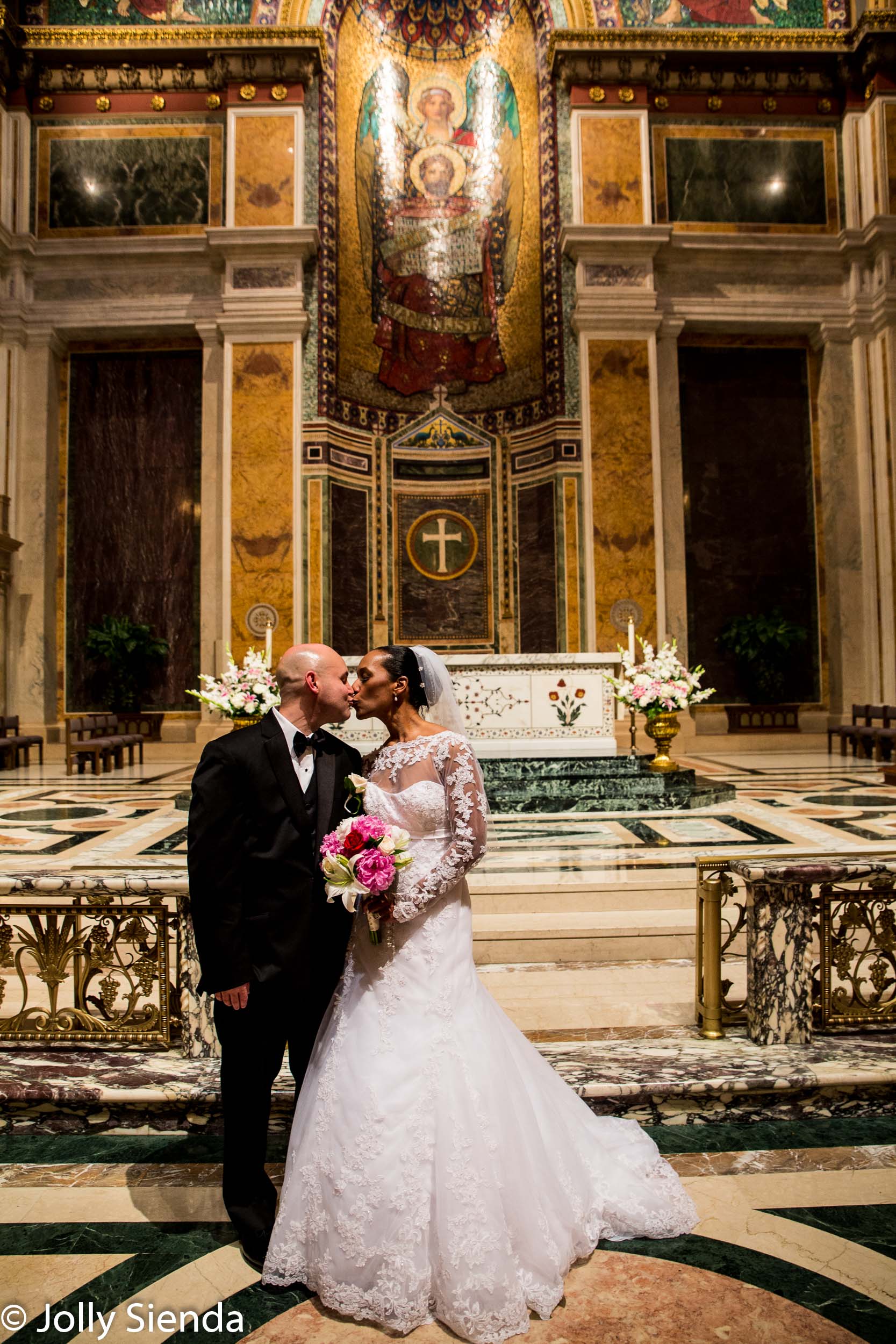 Portrait of a Bride and groom kiss at the wedding alter