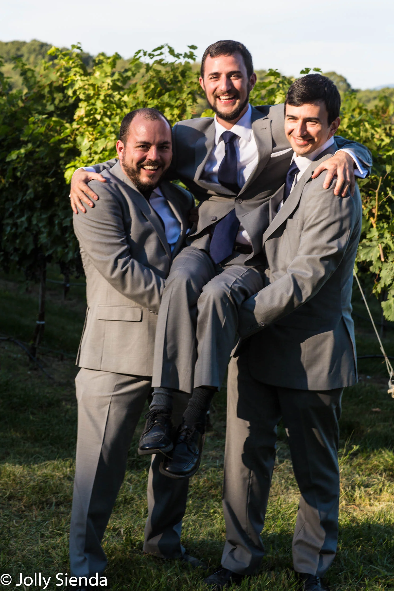 Groomsmen pick up the groom at his wedding