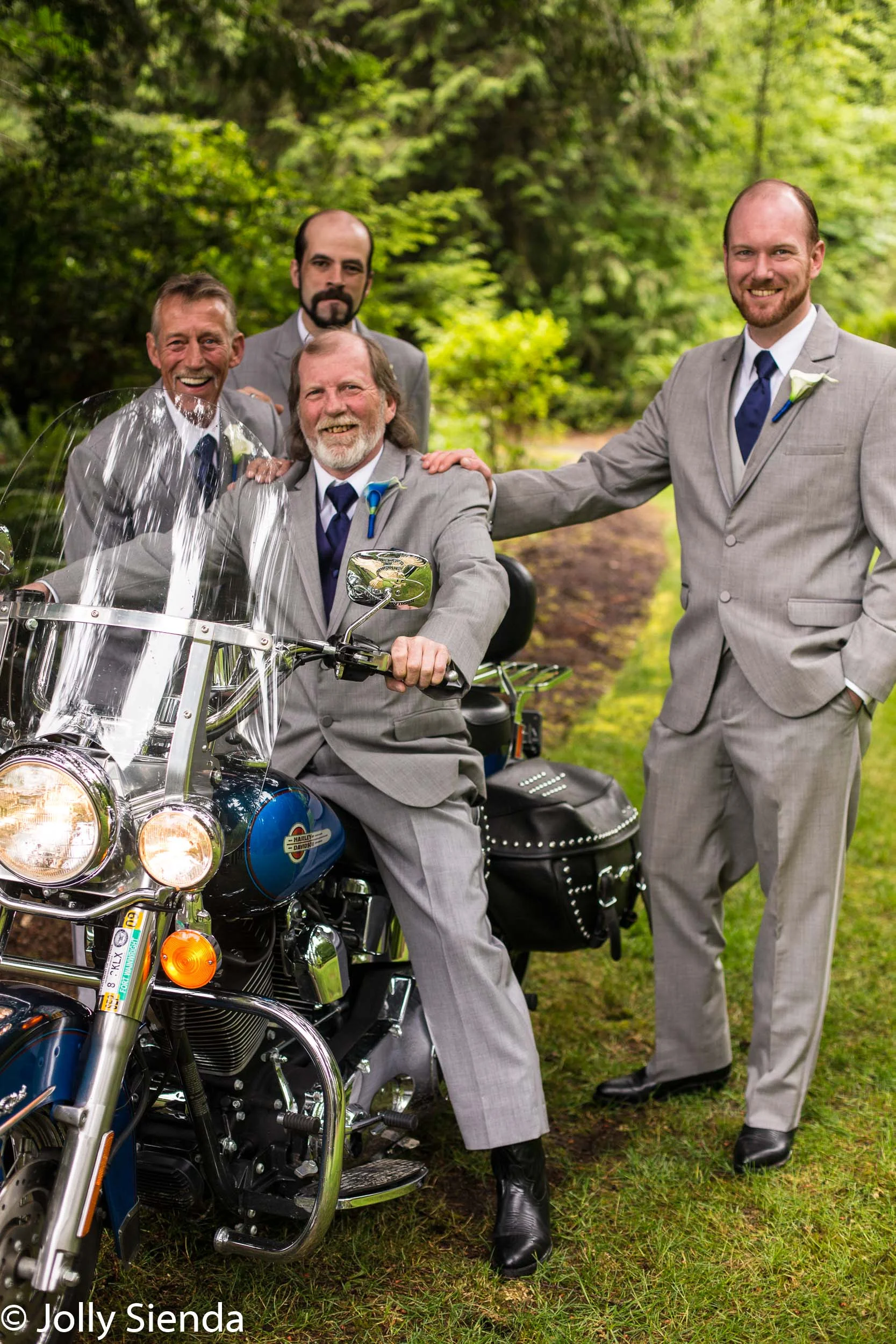 Groom and groomsmen at a wedding with their motorcycle