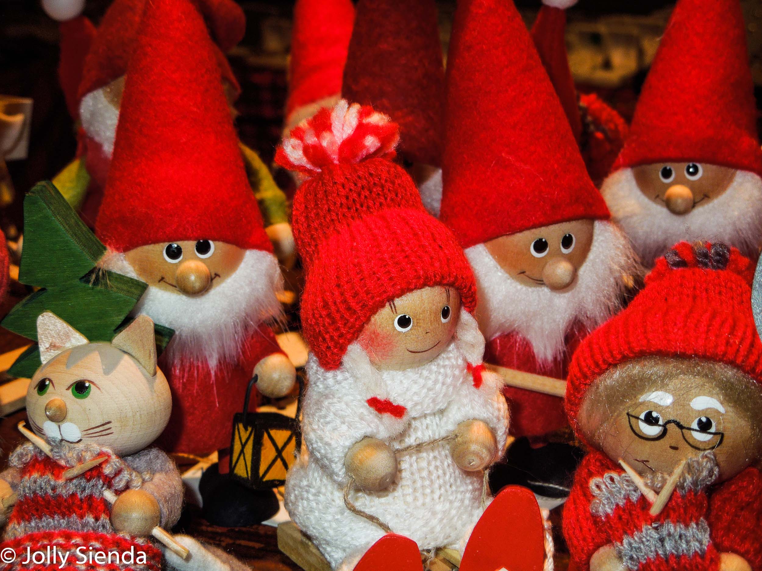 Swedish Norwegian wooden dolls with red hats, and a wooden cat 