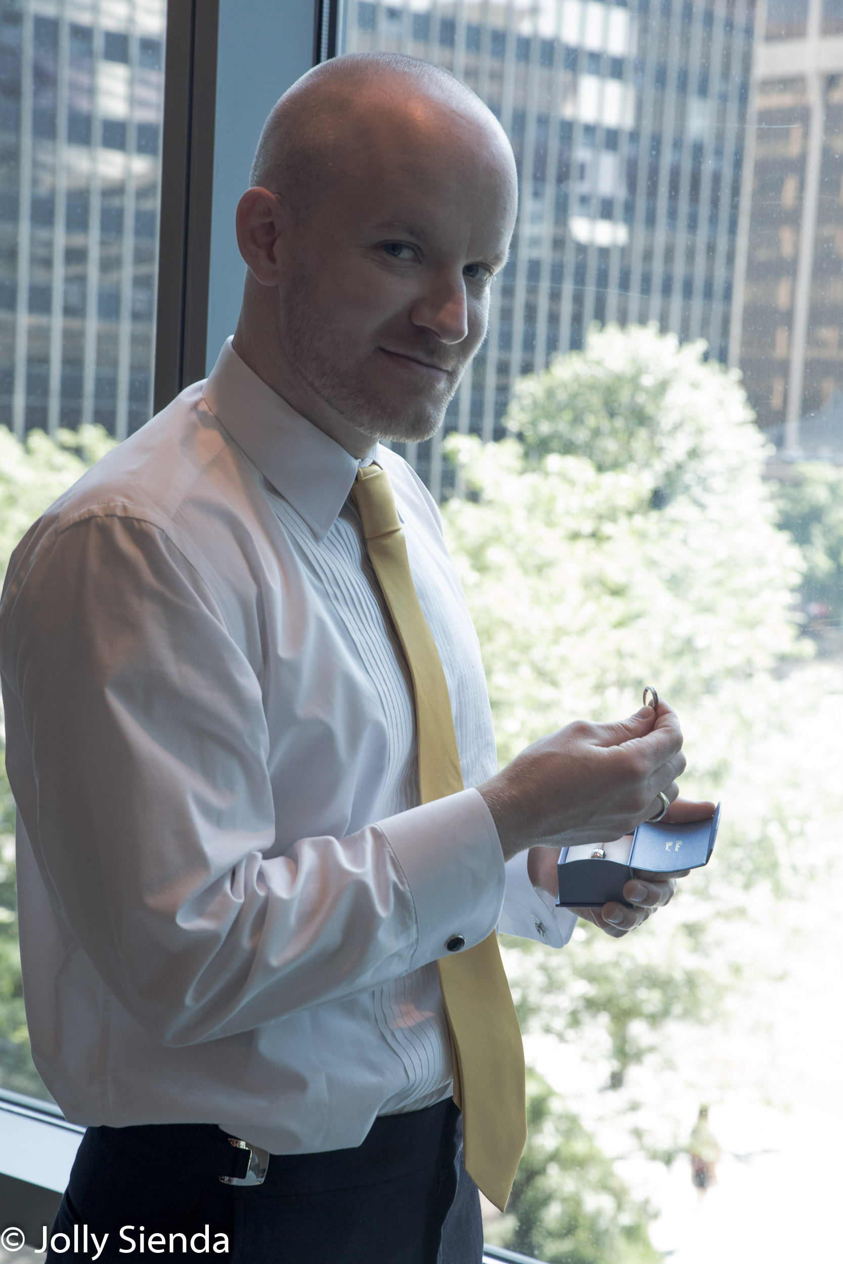 Portrait of a groom looking at the wedding rings