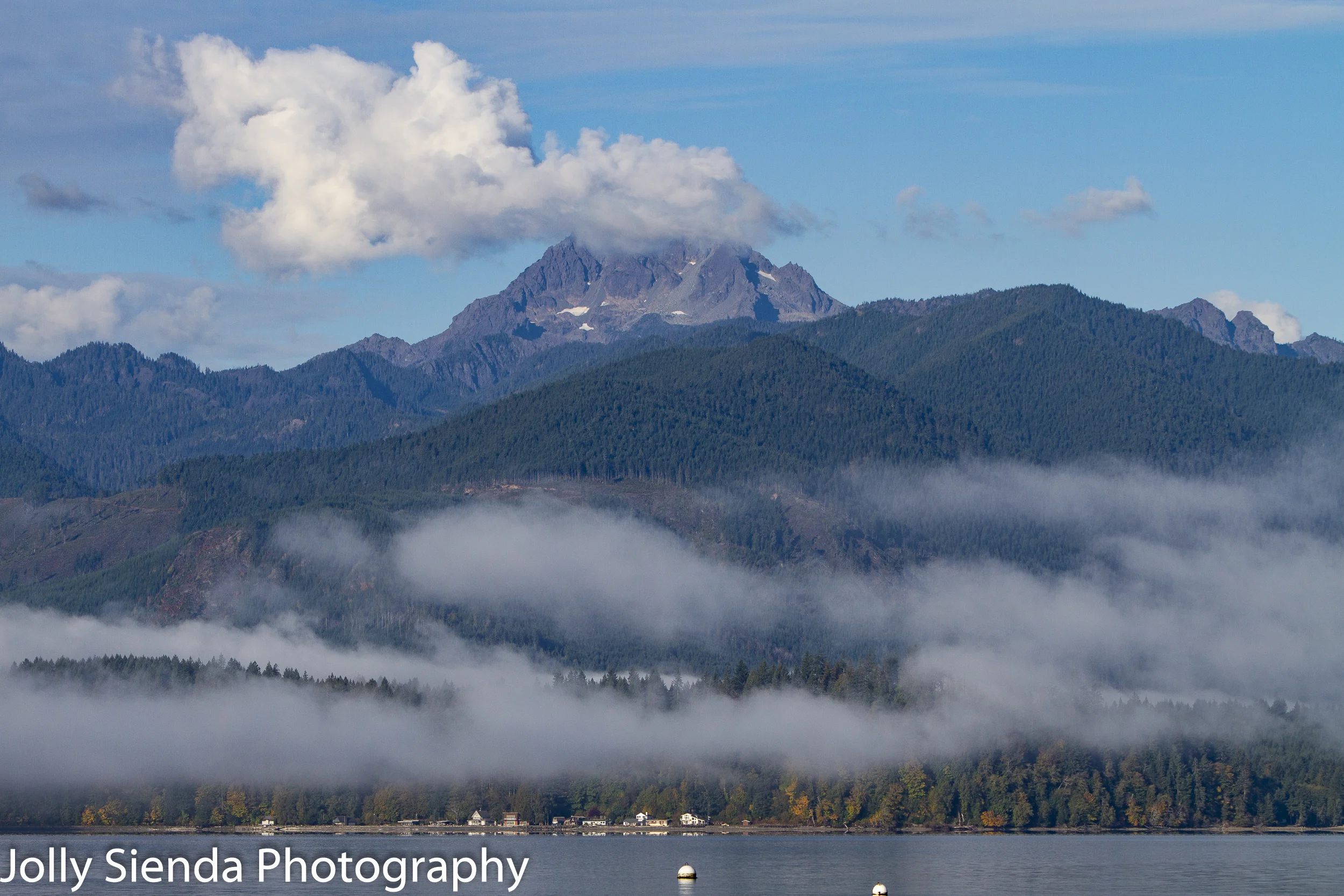 The Brothers Mountain, Olympic Mountains, peaks over light pillows of fog on the Hood Canal.