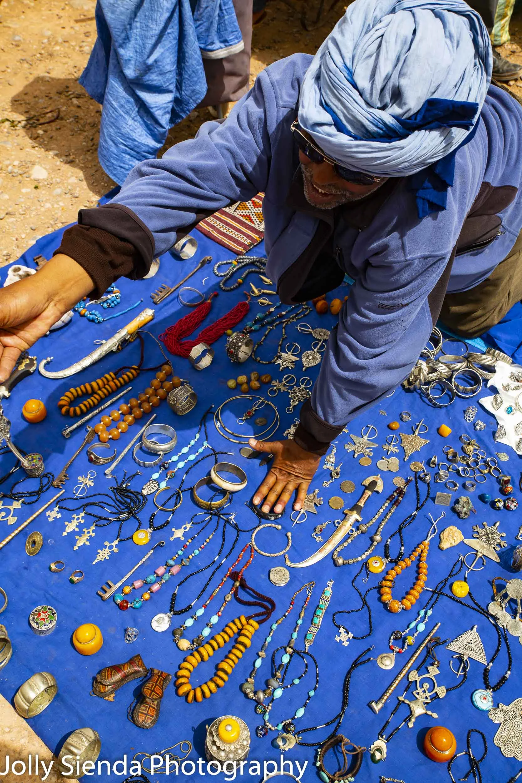 Man selling jewerly at an outdoor souk market
