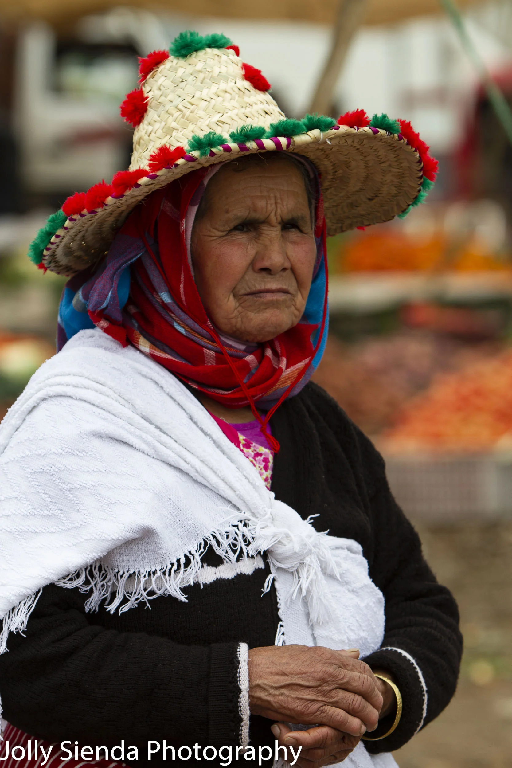 Old woman wears a Moroccan pom pom hat
