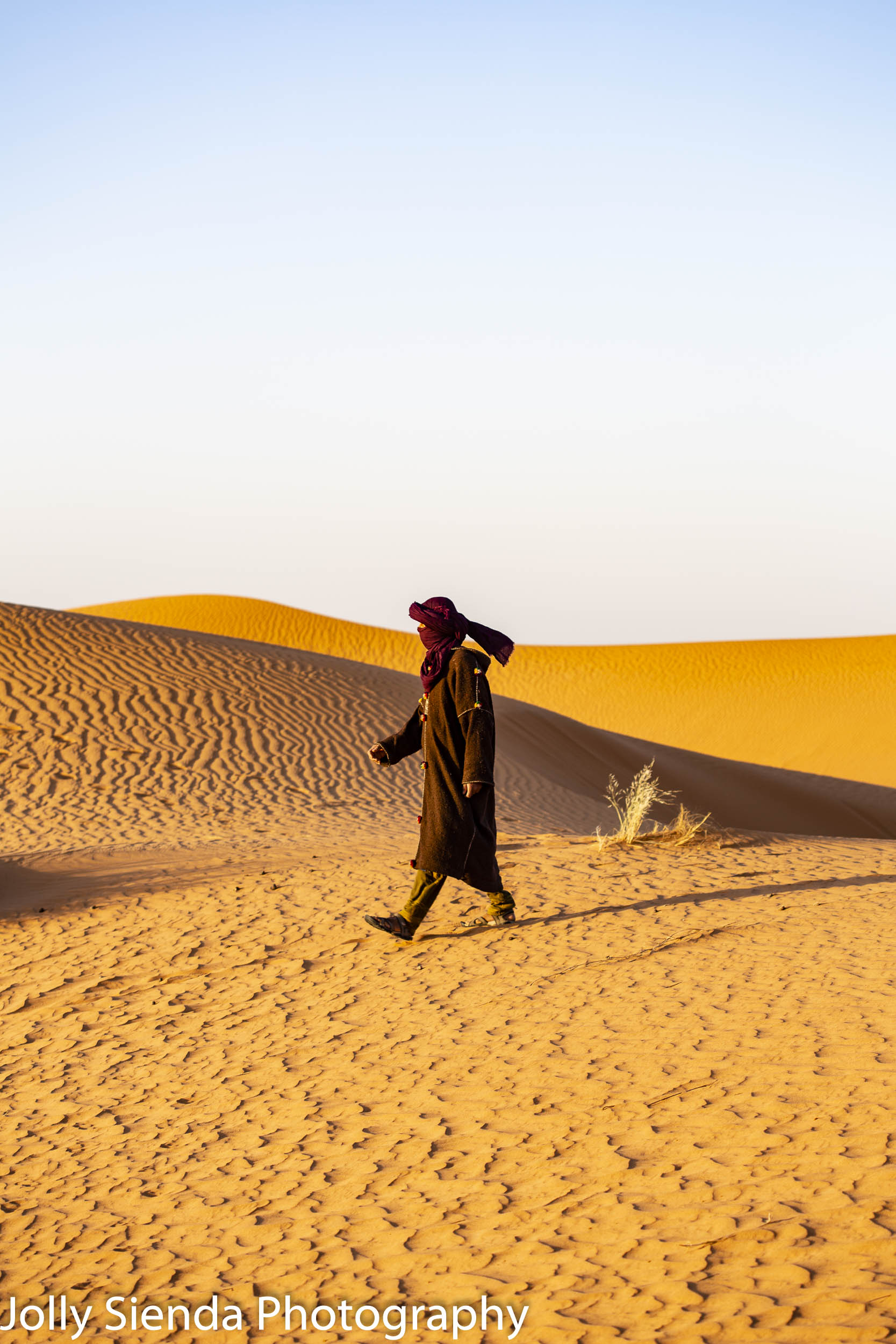 Camel herder walks the dunes at Erg Chebbi