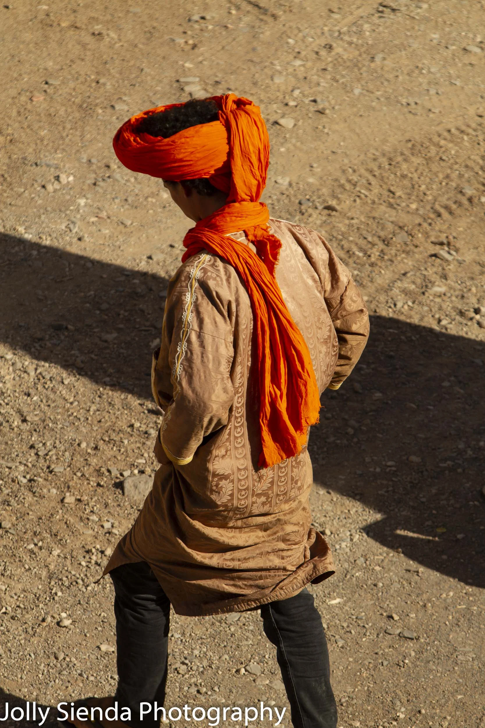 The orange turban and a shadow