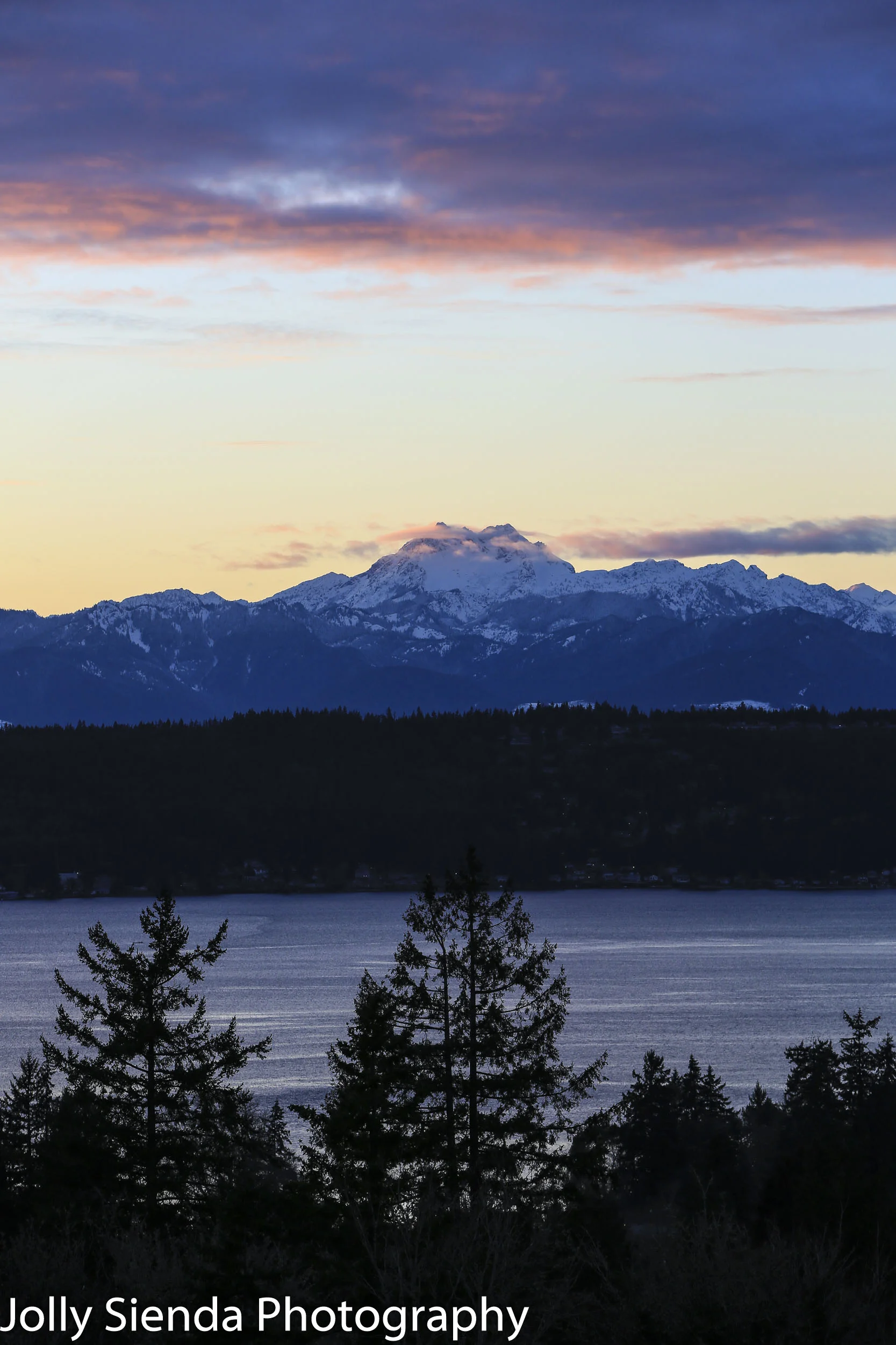 Pastel magenta sunset over the snow capped Brothers Mountain and