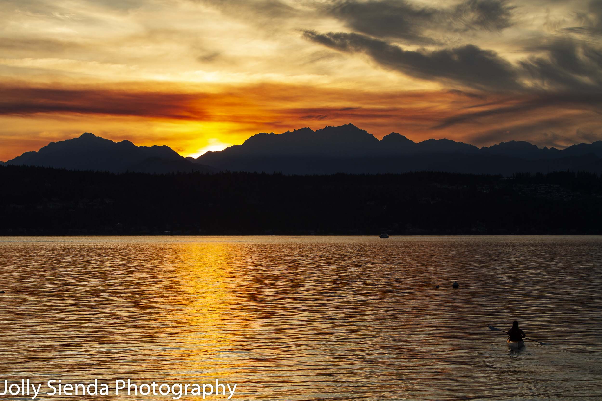 Kayaking at sunset towards the Olympic Mountains on the Puget So