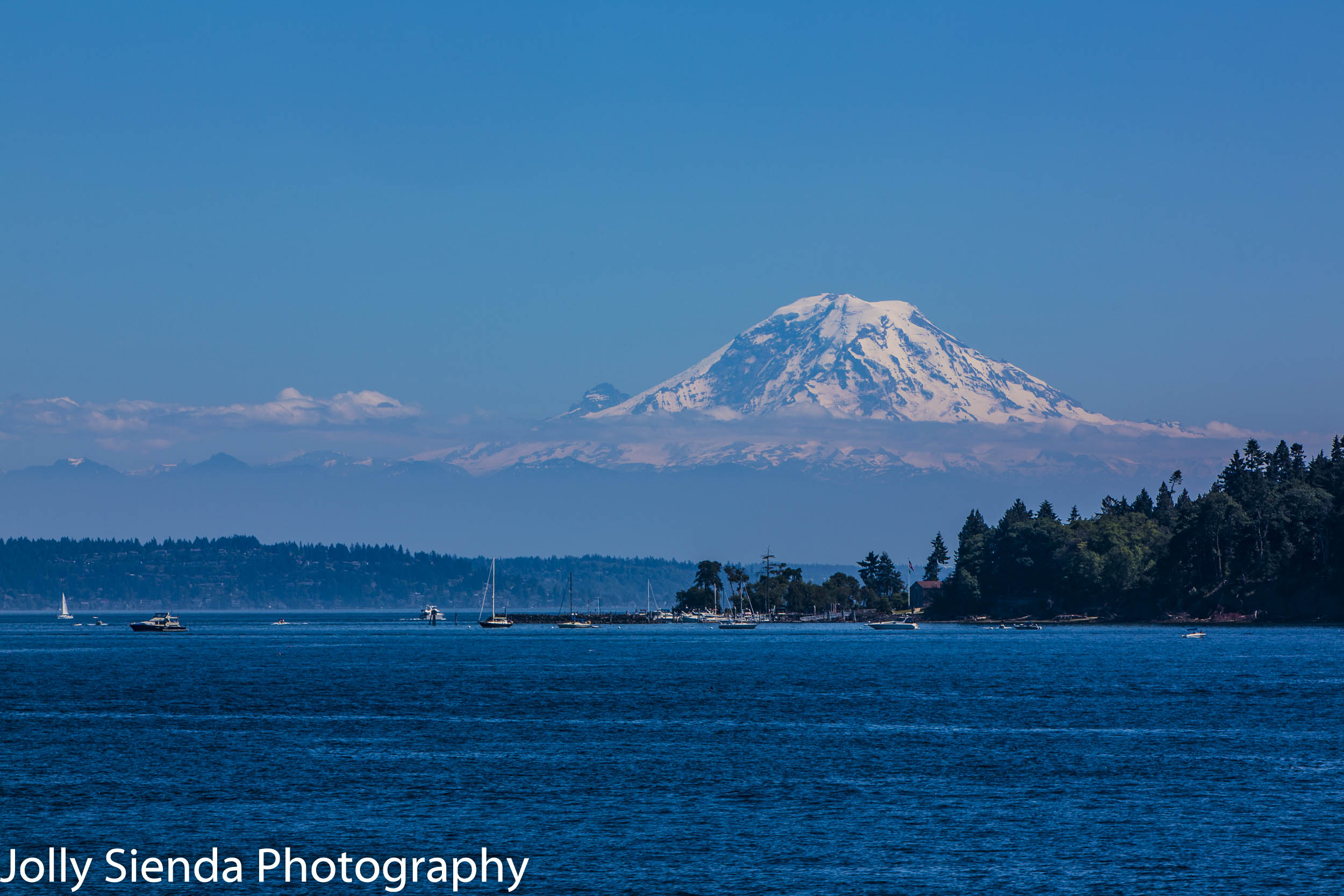 Mount Rainier with a cloud band towers over the Puget Sound and 