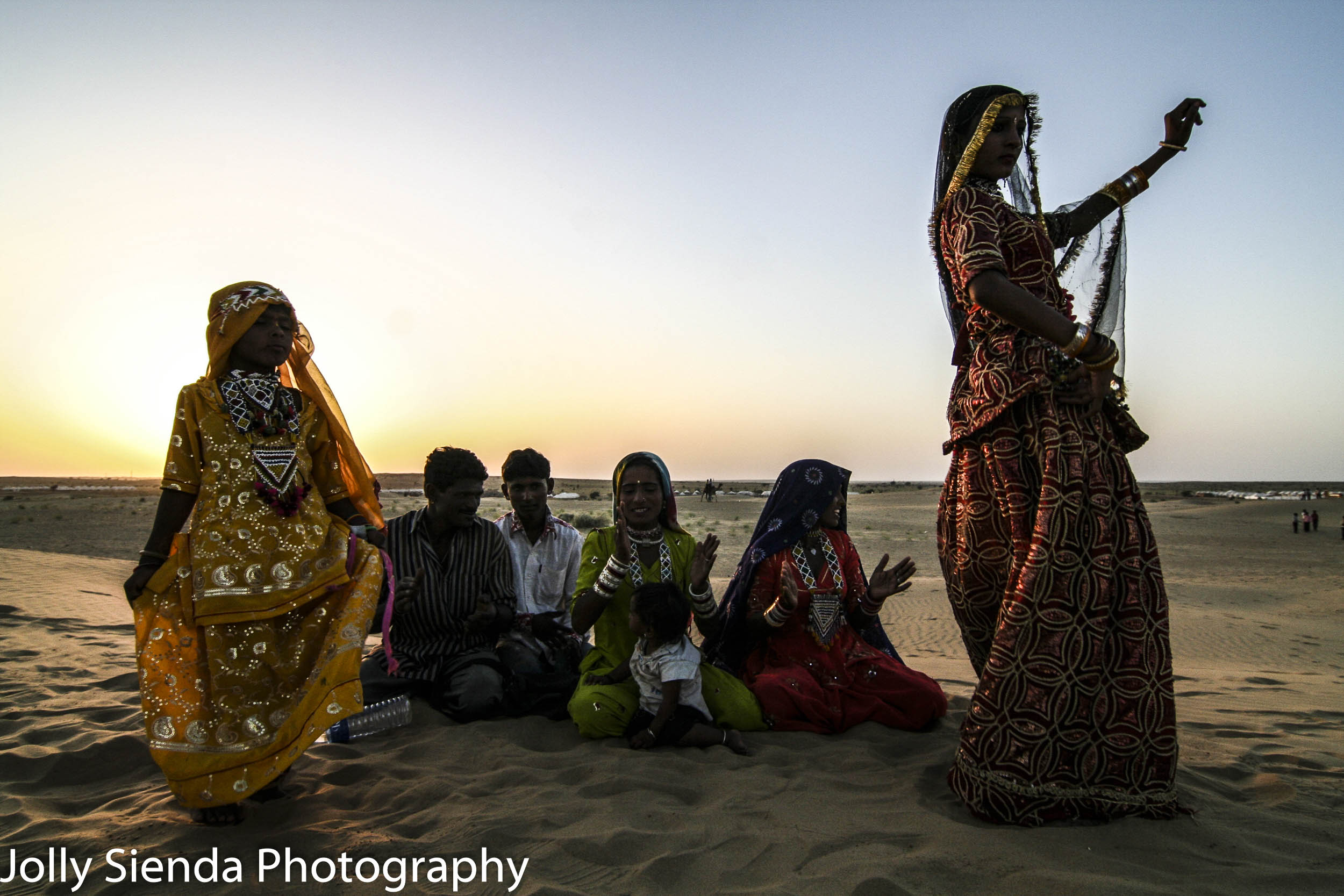 Bedouin, banjaras woman and child dance on sand, in tradional co