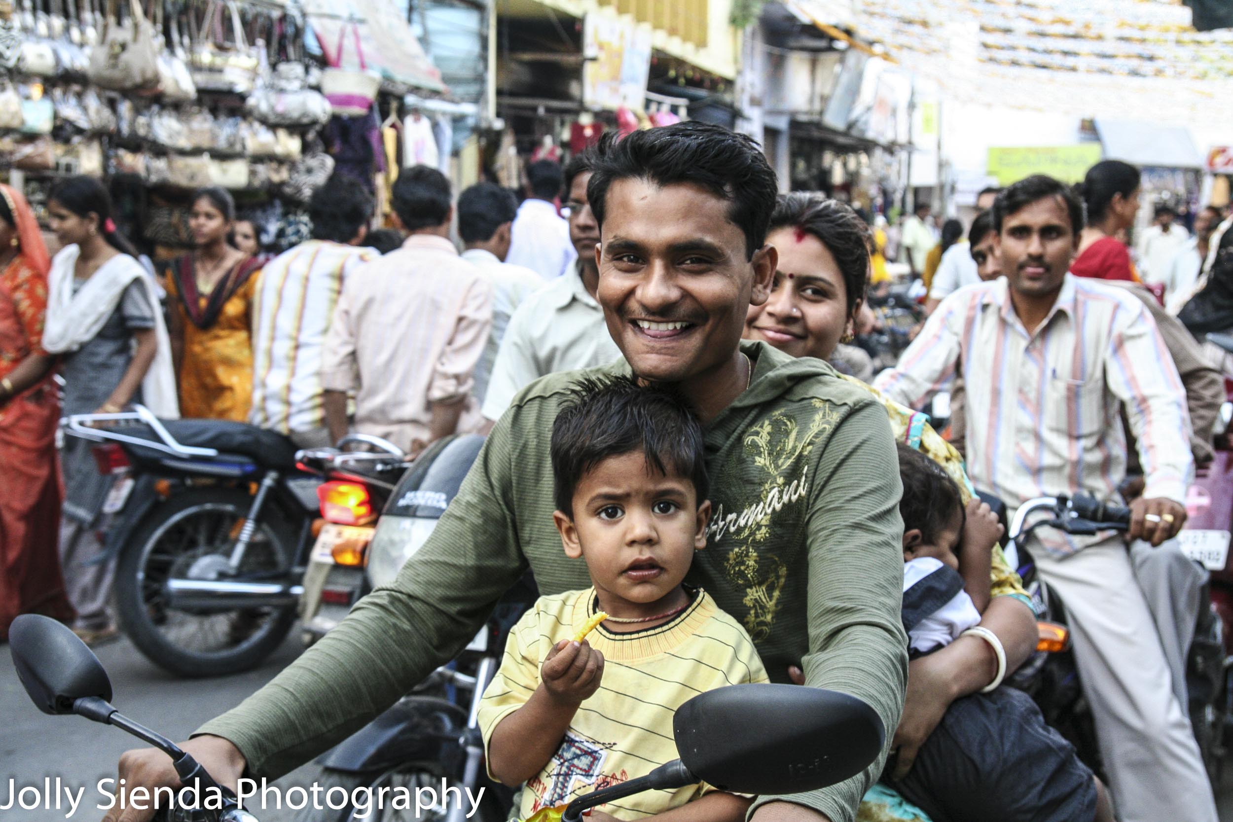 Family of four gets around the crowded market on a motorcyle