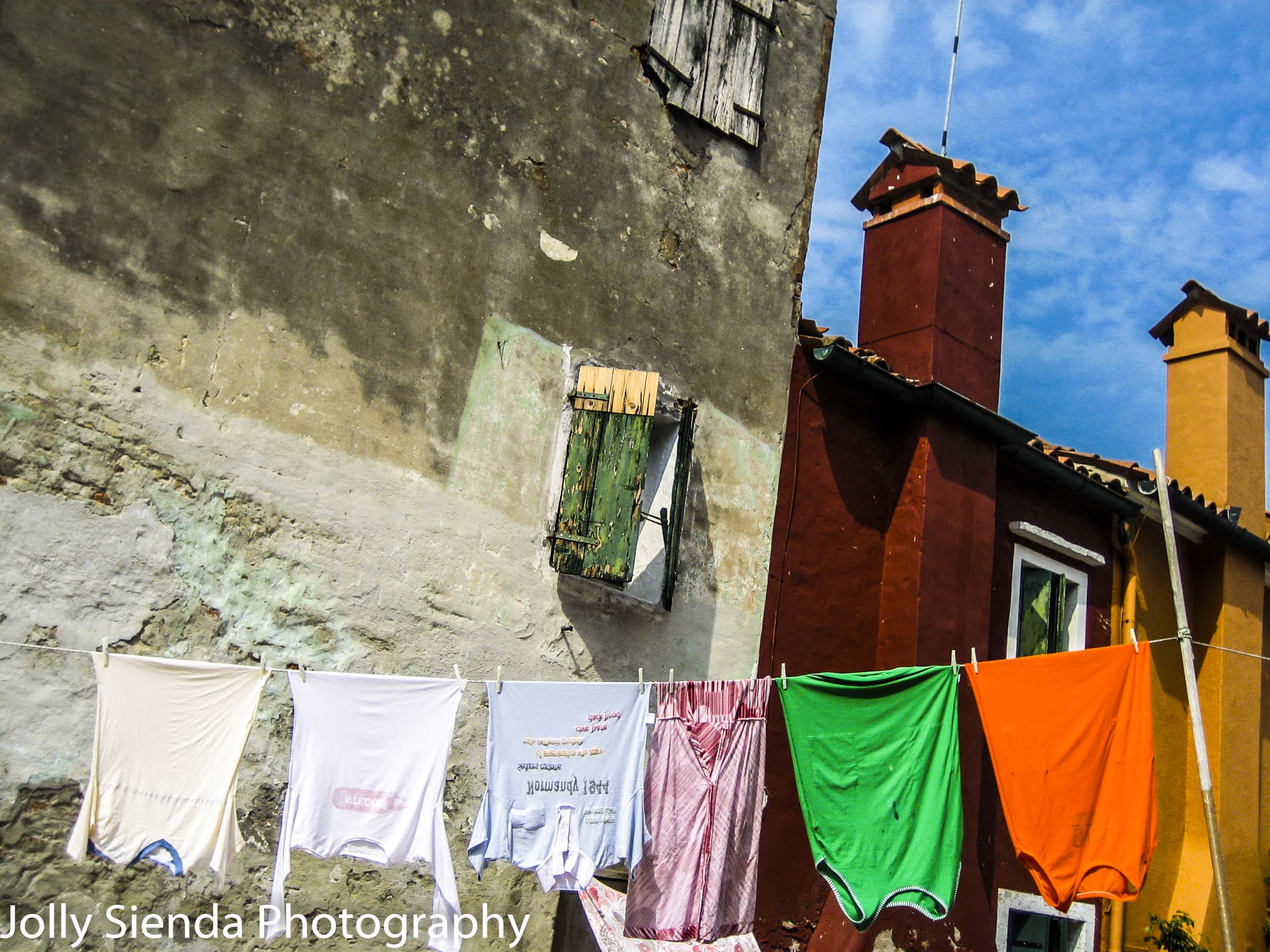 Laundry Hangs on a Clothes Line between Painted Buildings