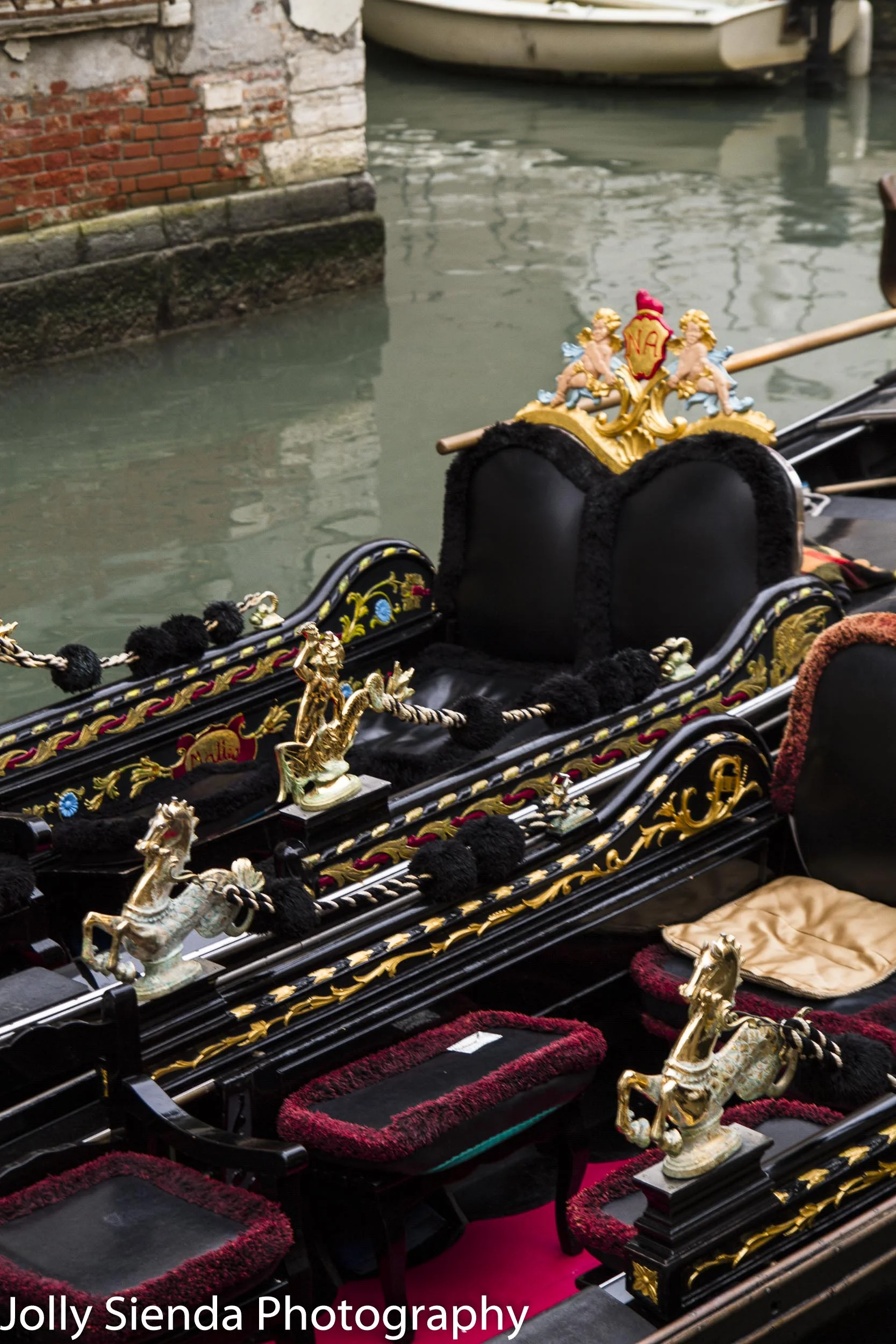 Artistic gondola interiors with golden seahorses and lovers cres