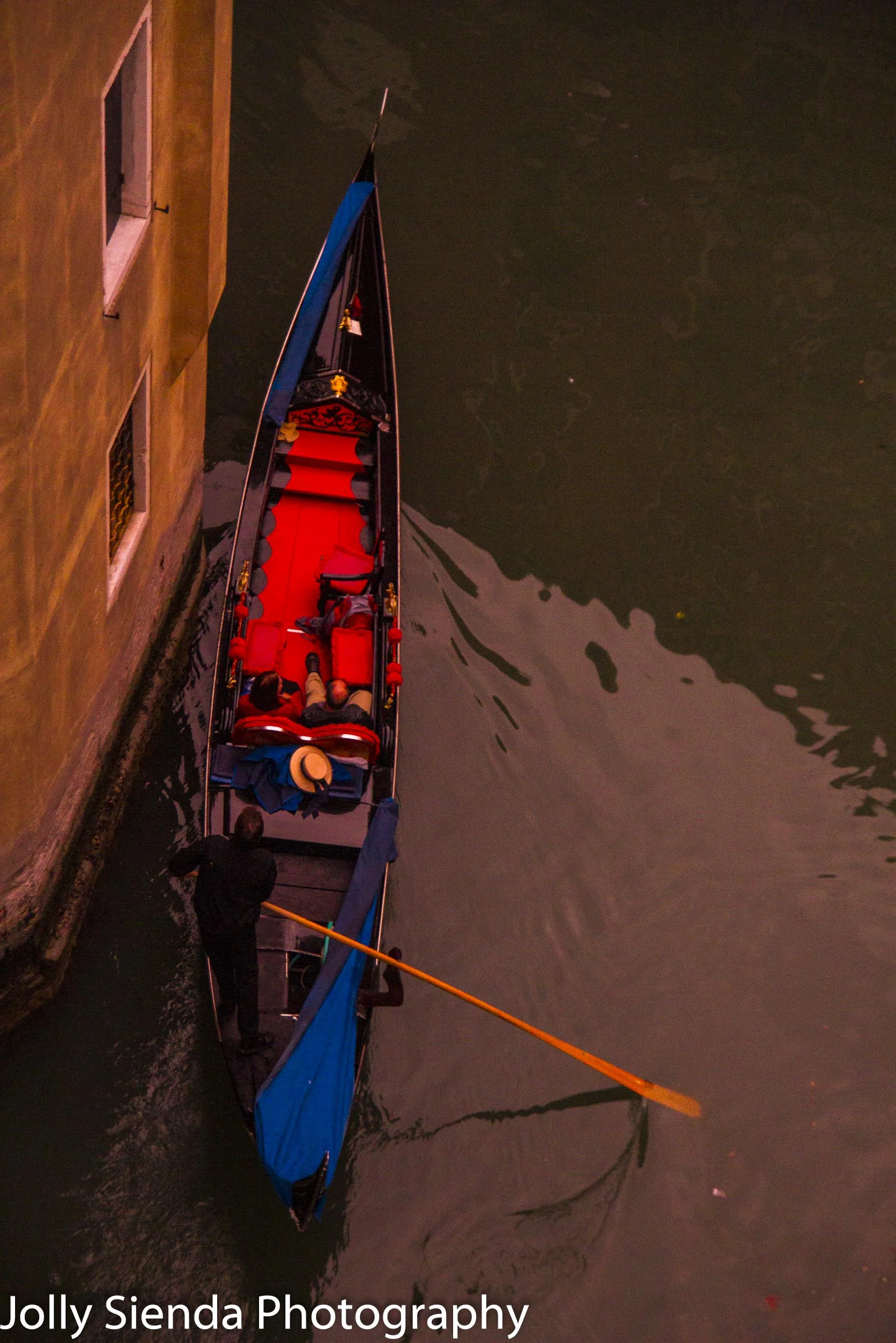 The red velvet interior of a gondola is centerstage as a couple
